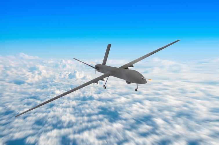 Unmanned military drone on patrol air territory at high altitude.